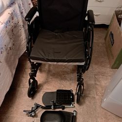 K3 guardian wheelchair with nylon upholstery and leg rests with 4 small extra wheels in the back 