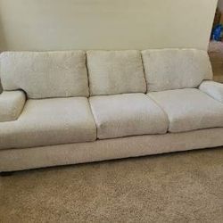 Modular Sectional With  Blue Pillows And Blue Ottoman 