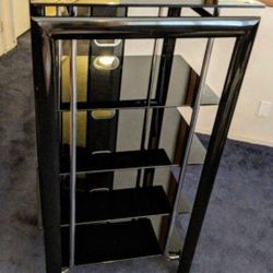 Entertainment center, black with 5 glass shelves. Very nice and heavy.