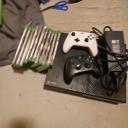 Xbox console with 2 game controllers and 11 games