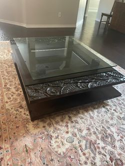 Large Centre Table with glass top and intricate wooden carvings.