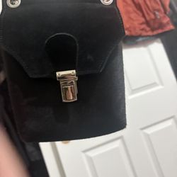 Crosstree Lane black calf hair and suede crossbody bag with a metal clasp closure.