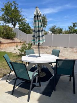 Patio Table 4 Chairs and an Umbrella