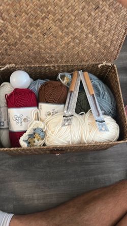 Wicker Basket with Yarn and Knitting Needles