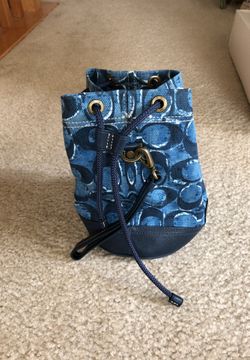 Cute small coach drawstring bag. Only has.a wrist strap excellent condition