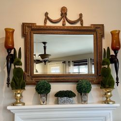 Antique gold mirror with decorative design
