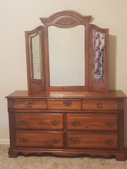 All wooden Dresser with 3 mirrors and 7 drawers.