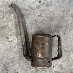 old oil can with raised letters 
