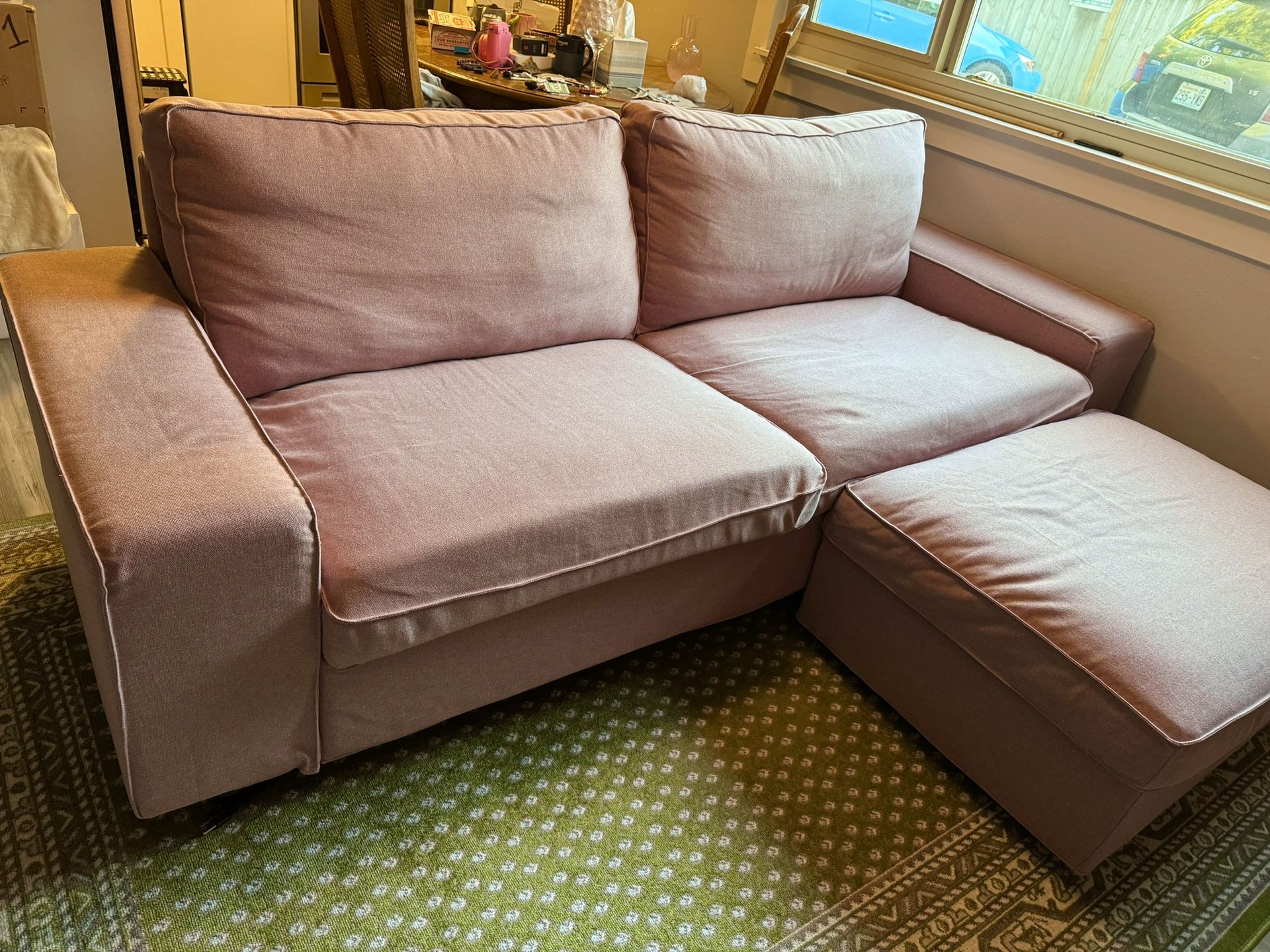 Pink Ikea Kivik sofa with matching ottoman