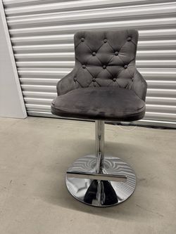 Gray tufted swivel bar chair