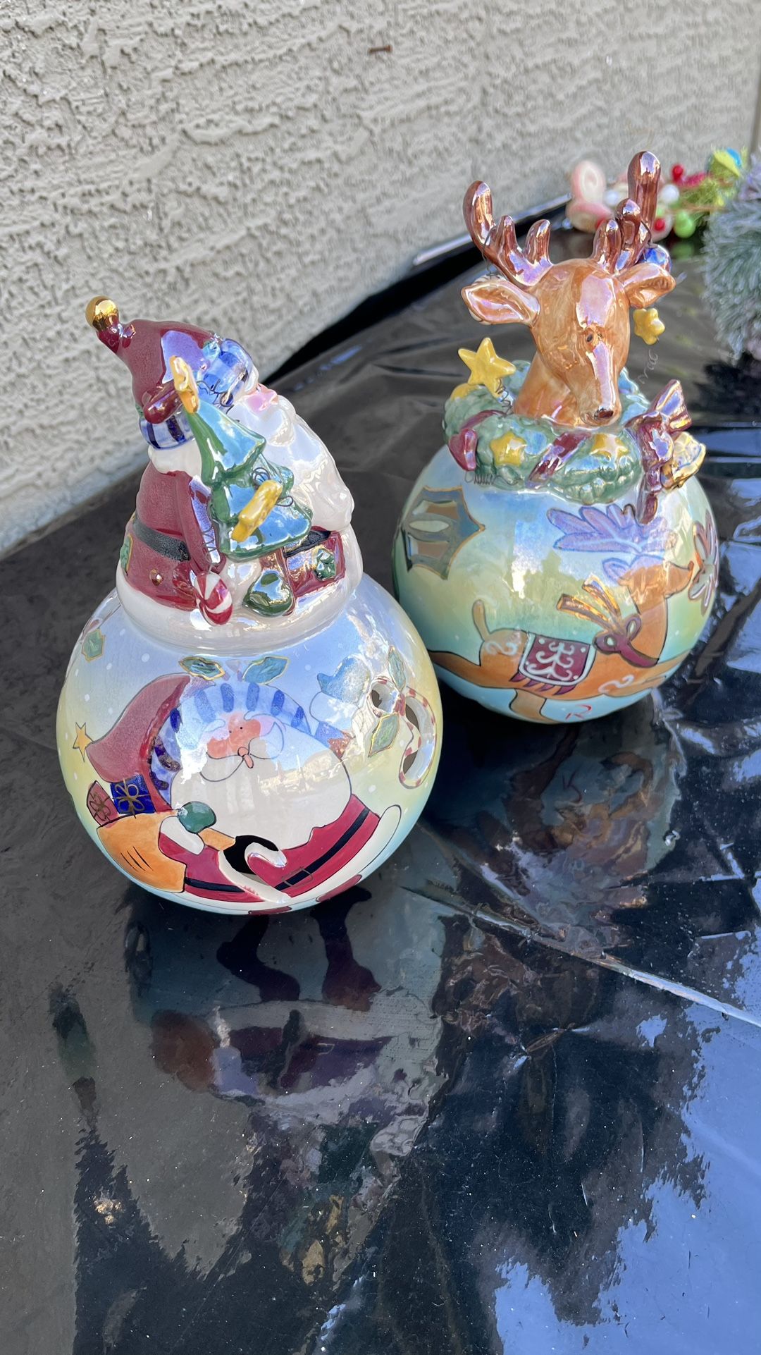 Christmas porcelain candle holders on top of the globe