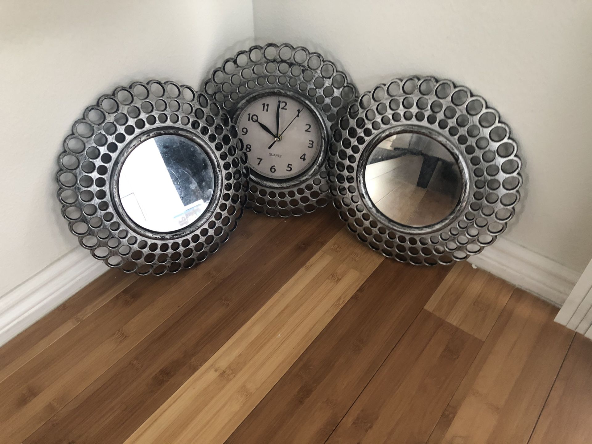 Two wall mirrors and clock