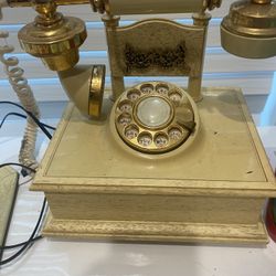 This is a Deco-Tel French Provincial-style rotary telephone. 