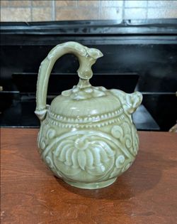 Vintage decorative Chinese celadon porcelain reverse-flow teapot featuring floral carvings and arched loop handle
