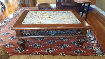 Beautiful antique coffee table w/marble inlay encrusted w / intricate metal detail around the perimeter. Like new asking 1995