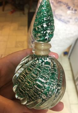 Heavy green with silver flakes perfume bottle has a few little chips on the bottom of stopper