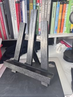 a 5x7 inch collage of newspaper that has been ripped and dyed slightly to offer depth within layers   it comes with the distressed black stand for dis