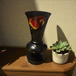 hand-painted black vase featuring a colorful parrot design