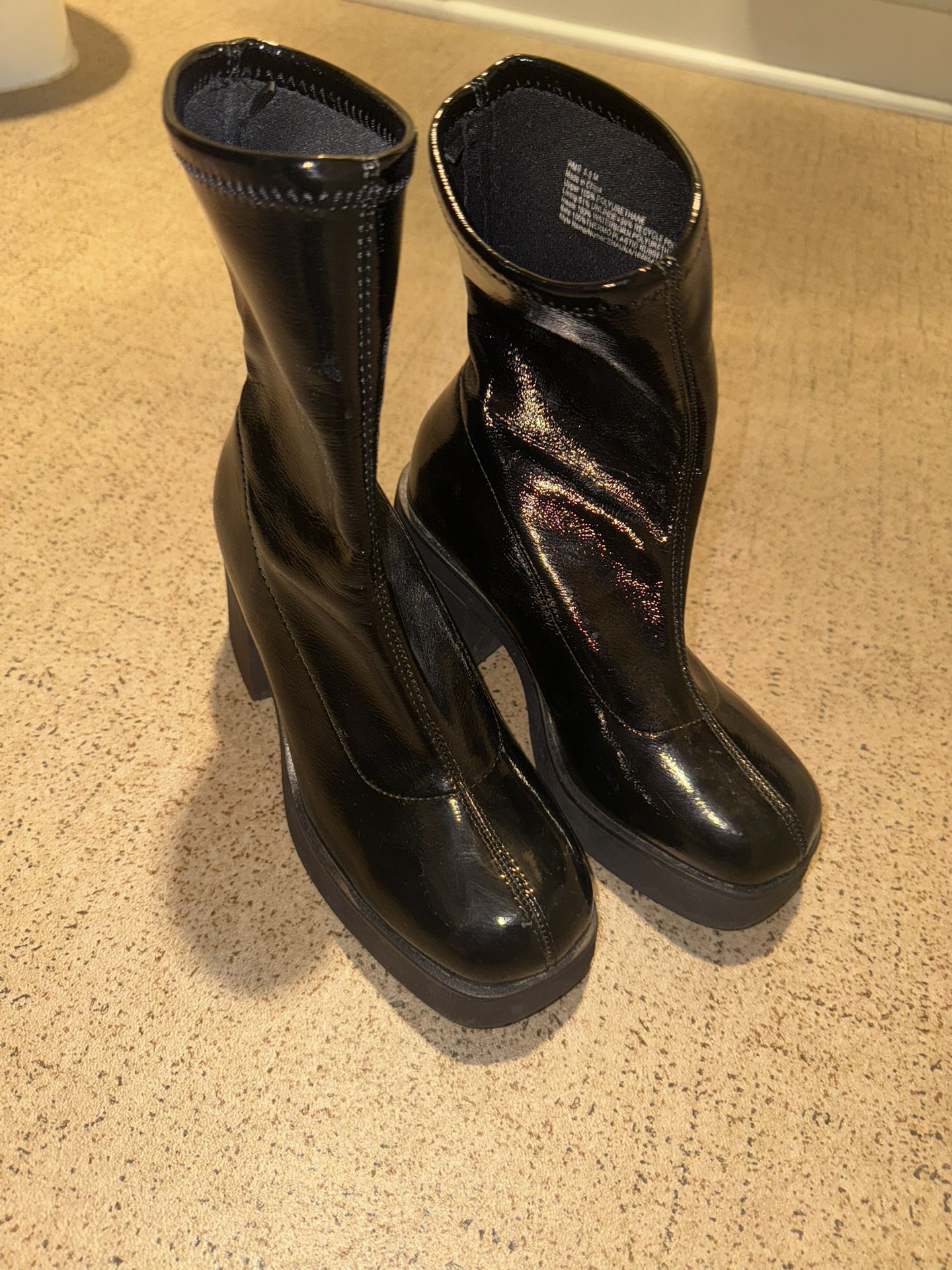 Black glossy ankle high boots