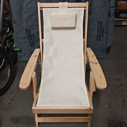 Sling Chair With a Natural Frame And Beige Cushion