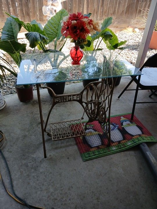 It's an old sewing machine frame with glass on top.