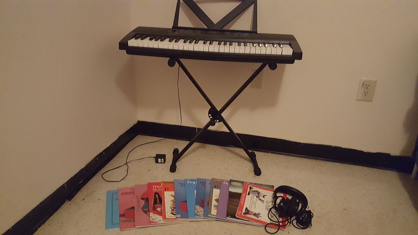 Lexington LX-2154 Keyboard with stand, headphones, and books