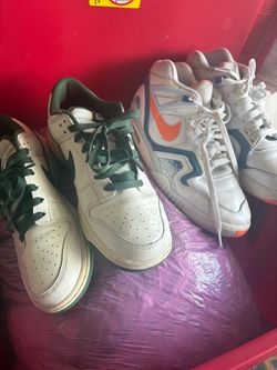 2 pairs if Nike shoes for boys