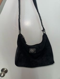 DKNY hobo bag made of suede with a silver logo plaque.