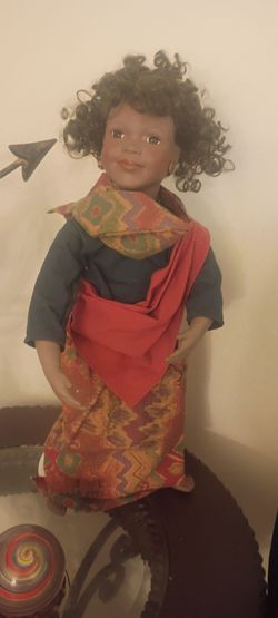 Antique collectible doll don't know much about her but she is a adult of color and she is porcelain