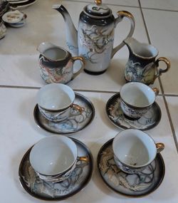 Vintage Japanese Moriage Dragonware Porcelain Tea Set. Total 11 individual pieces: 1 lidded teapot, 2 creamers, 4 teacups, 2.5 Diameter, 2.5" H. 4 sau