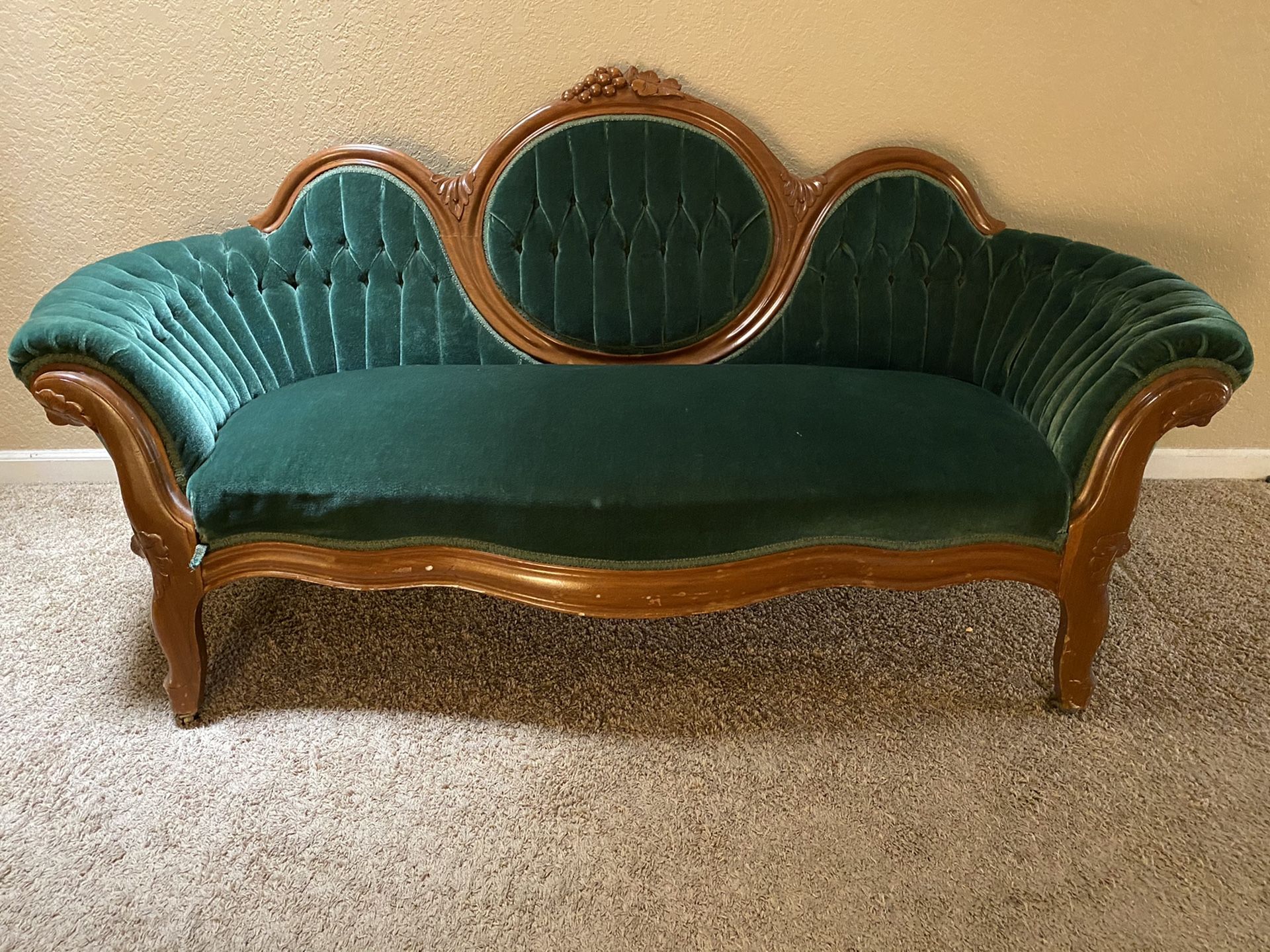 Antique emerald green velvet couch