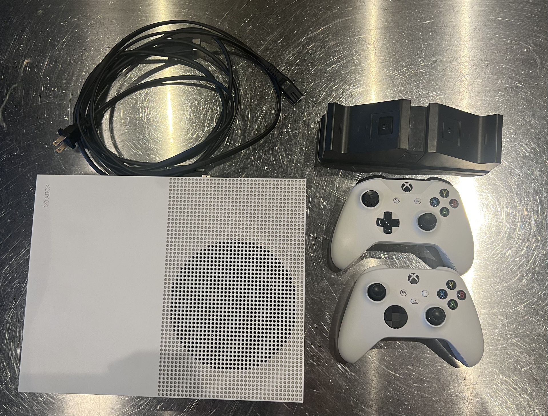 Xbox One S, 2 controllers, rechargeable battery packs, and charging dock