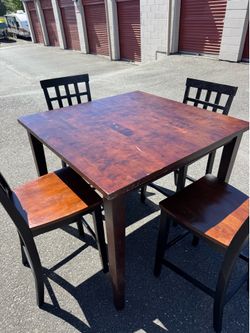 Square wooden high table and four chairs