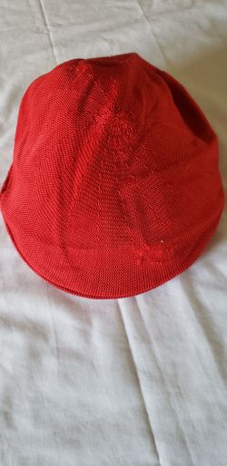 a red Kangol Tropic 504 Ventair cap made from a textured, breathable knit material