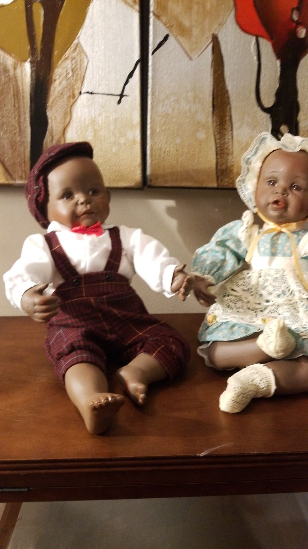 Collectible dolls with certificate and wooden doll cabinet