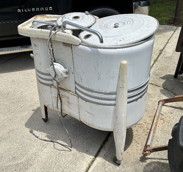 Vintage 1940s or 1950s. It is a combination washer and spin dryer.
