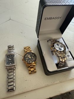 Three watches sold as a lot. Silver-tone Emporio Armani rectangular watch with black Roman numeral dial. Gold-tone Michael Kors chronograph with black