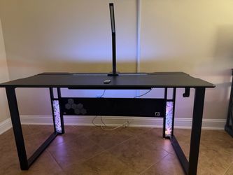 Gaming or work desk with chair, lamp and remote