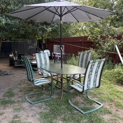 Table And Chairs And Umbrella 