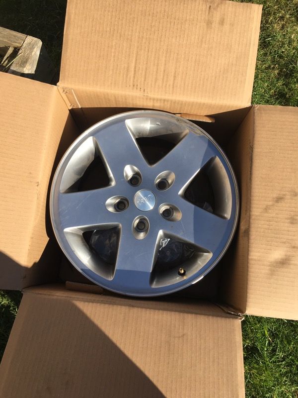 Set of 5 17" stock Jeep wheels.