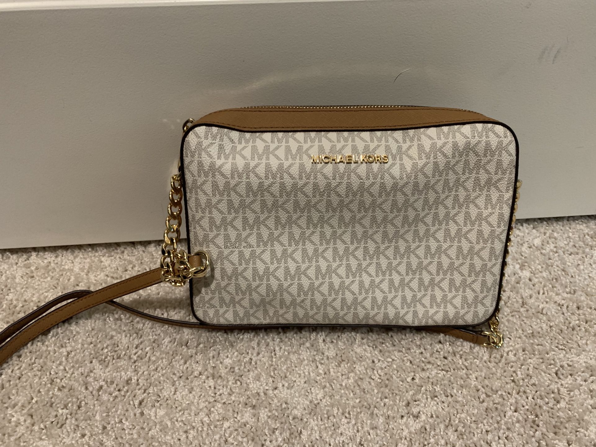 Authentic MK purse. Brown/tanish white cross body. Brand new and never used. Need gone ASAP. Make an offer