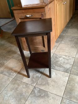 Wooden square table approximately 25” tall and 15” square, great looking dark Cherry