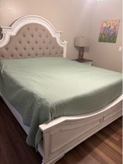 King size bed with a purple mattress, boxspring, and bedding King size bed with a purple mattress, boxspring, and bedding