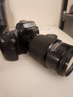 Minolta Maxxum 300si 35mm SLR camera.  And Sigma 75-300mm f/4.5-5.6 Multi-Coated autofocus lens.