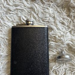 Black glittery flask with funnel