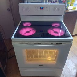 Like New Condition, Whirlpool 5 Burner glass top stove with Self Cleaning Oven. Looks & Works Like New