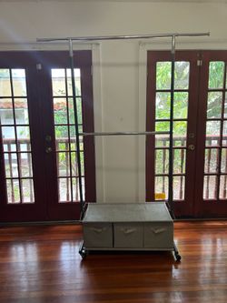 (2) clothes racks on wheels with three drawer storage space