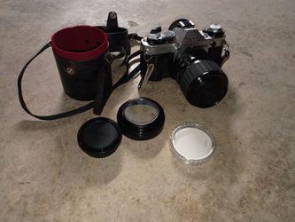 AE-1 cannon vintage camera and the attachment s in the photo.