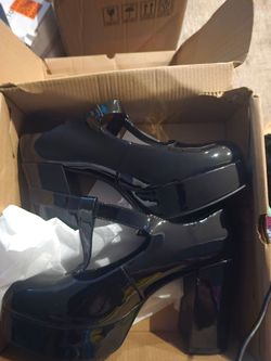 Black patent-look platform Mary Jane heels.