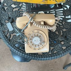 Vintage phone with phone cord still attached 